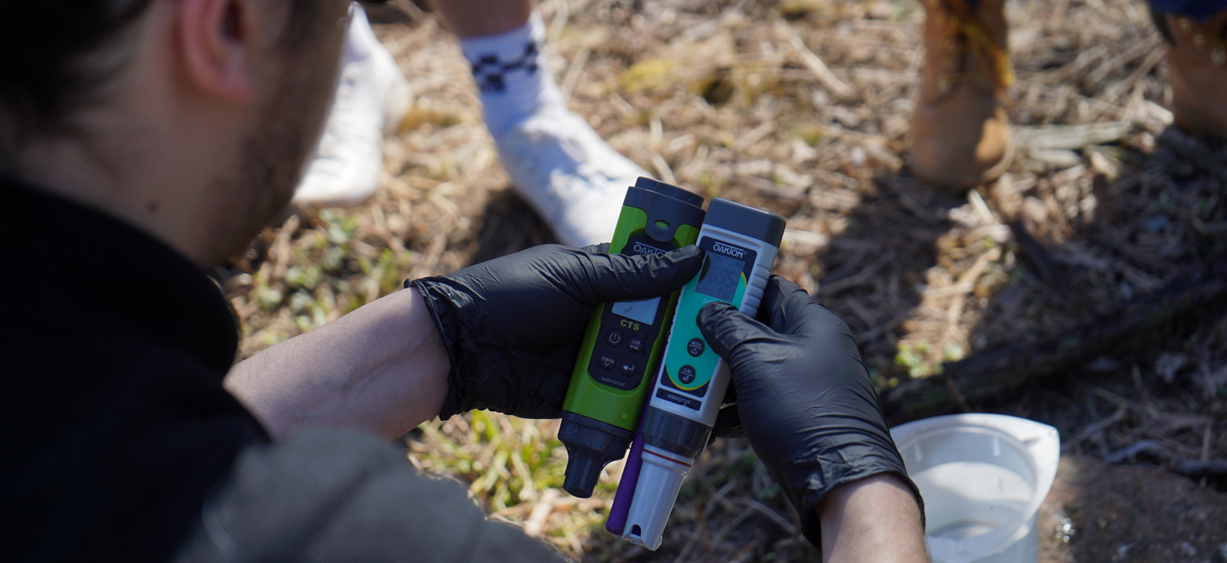 City employee taking water and soil samples.