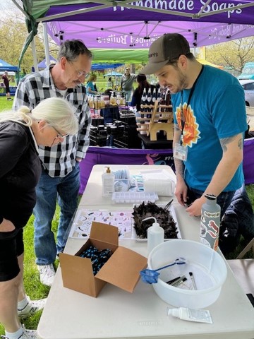 City employee giving educational demonstration at an event.